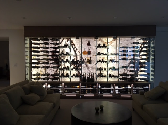 Backlit Zulio SkinnyStone wine cellar wall with custom millwork